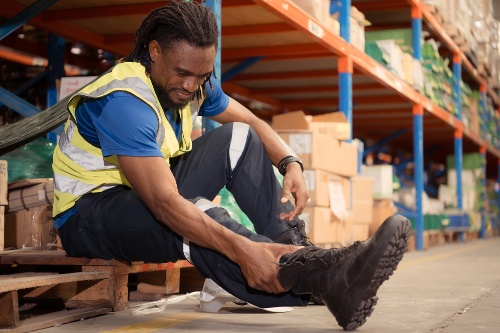 warehouse-worker-with-pain-after-a-leg-accident-wh-2023-07-25-20-21-41-utc-1