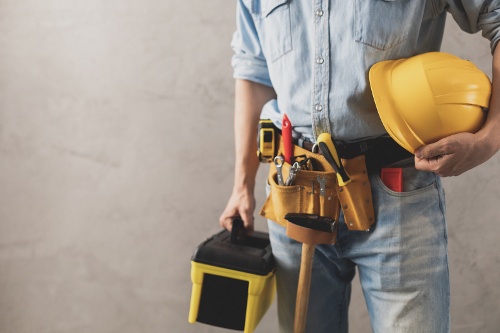 worker-man-holding-construction-helmet-and-toolbox-2022-12-15-20-20-10-utc-1